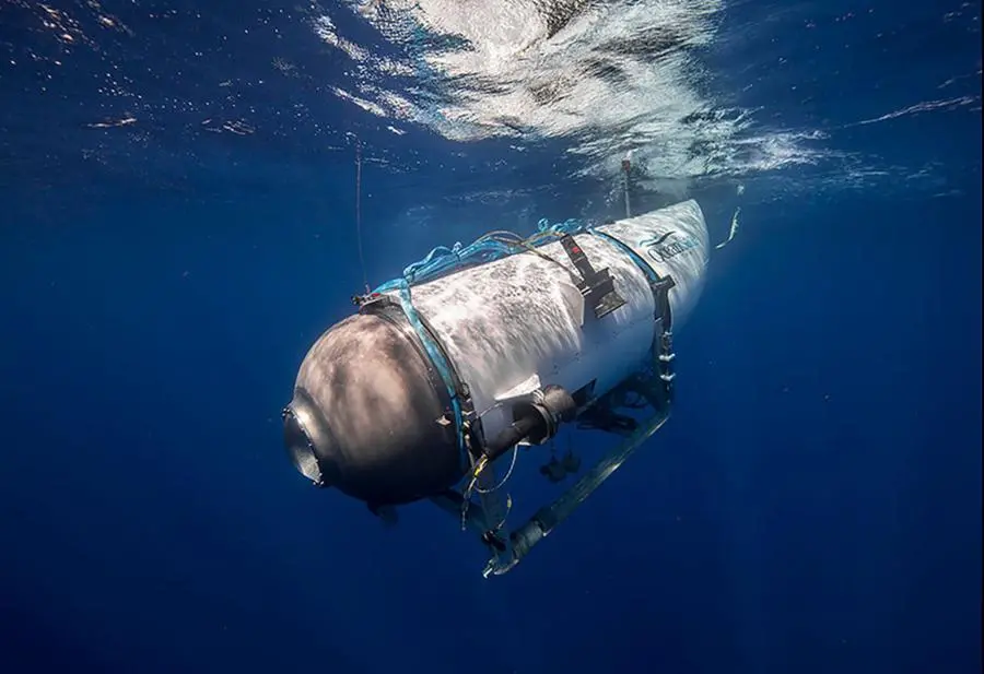 This undated image courtesy of OceanGate Expeditions, shows their Titan submersible beginning a descent. - Rescue teams expanded their search underwater on June 20, 2023, as they raced against time to find a Titan deep-diving tourist submersible that went missing near the wreck of the Titanic with five people on board and limited oxygen. All communication was lost with the 21-foot (6.5-meter) Titan craft during a descent June 18 to the Titanic, which sits at a depth of crushing pressure more than two miles (nearly four kilometers) below the surface of the North Atlantic. (Photo by Handout / OceanGate Expeditions / AFP)