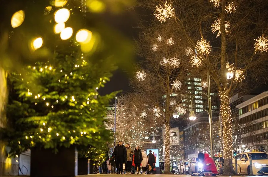 People walk along the street near next to the department store Kaufhaus des Westens \\\"KaDeWe\\\" during Christmas season in Berlin, Germany, December 18, 2023. REUTERS/Lisi Niesner