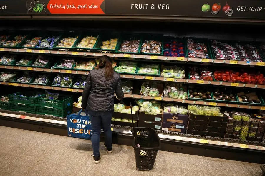 A shopper looks at fruit and vegetables inside an ALDI supermarket near Altrincham, Britain, February 20, 2023. REUTERS/Phil Noble , Reuters/REUTERS