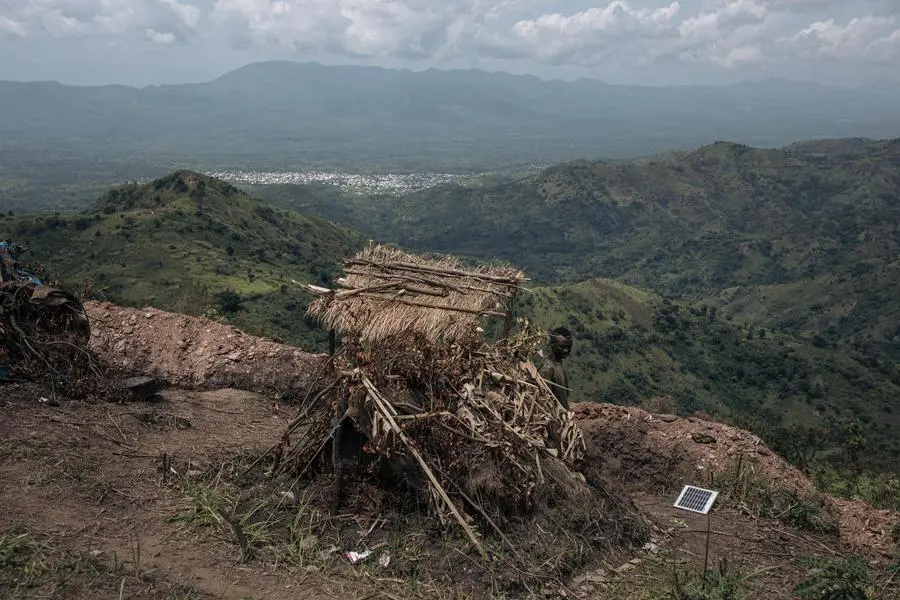 (FILES) An FARDC (Armed Forces of the DRC) soldier stands at a frontline military position above the town of Kibirizi, controlled by the M23 rebellion, North Kivu province, eastern Democratic Republic of Congo, on May 14, 2024. Some 3,000-4,000 Rwandan soldiers are fighting the Congolese army alongside the M23 rebels in the east of the Democratic Republic of Congo, according to a report by UN experts seen by AFP on July 8, 2024. (Photo by ALEXIS HUGUET / AFP) , Agence France-Presse (AFP)/AFP