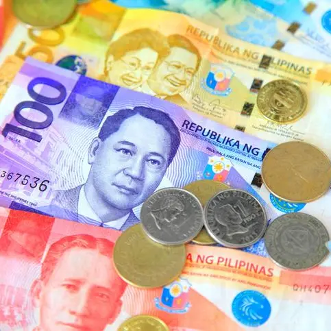 Peso hits near low, closes at P57 against US dollar
