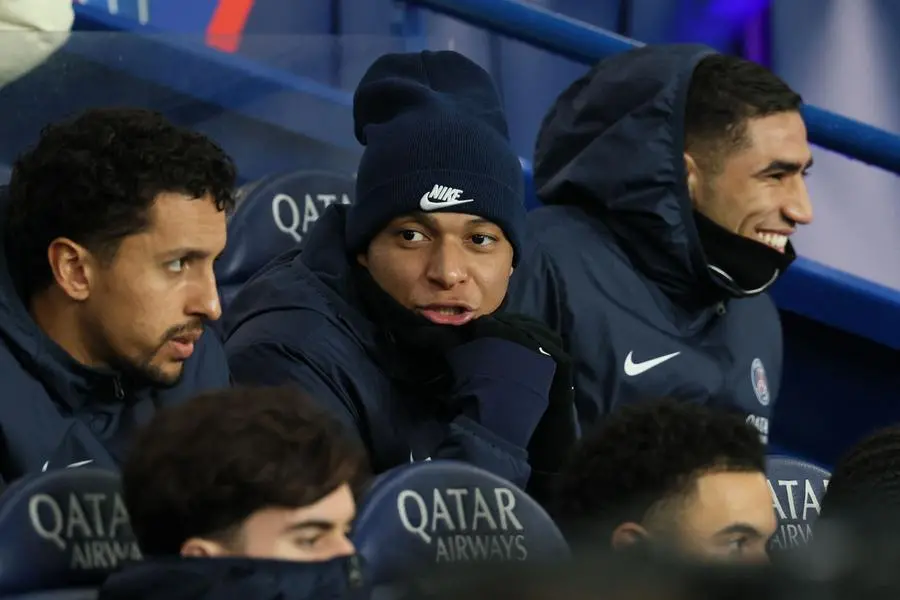 Paris Saint-Germain\\'s Brazilian defender #05 Marquinhos (L), Paris Saint-Germain\\'s French forward #07 Kylian Mbappe (C) and Paris Saint-Germain\\'s Moroccan defender #02 Achraf Hakimi (R) react as they look on from the bench during the French L1 football match between Paris Saint-Germain (PSG) and Lille LOSC at the Parc des Princes stadium in Paris, on February 10, 2024. (Photo by ALAIN JOCARD / AFP) , Agence France-Presse (AFP)/AFP