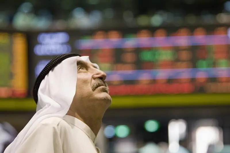 A Kuwaiti investor keeps track of stock prices at the Kuwait Stock Market October 13,2008. Stephanie McGehee, Reuters , Reuters Images
