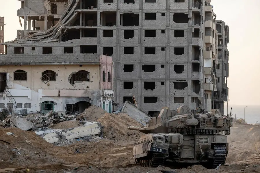 An Israeli tank manoeuvres through rubble, amid the ongoing ground invasion against Palestinian Islamist group Hamas in the northern Gaza Strip, November 8, 2023. REUTERS/Ronen Zvulun , Reuters