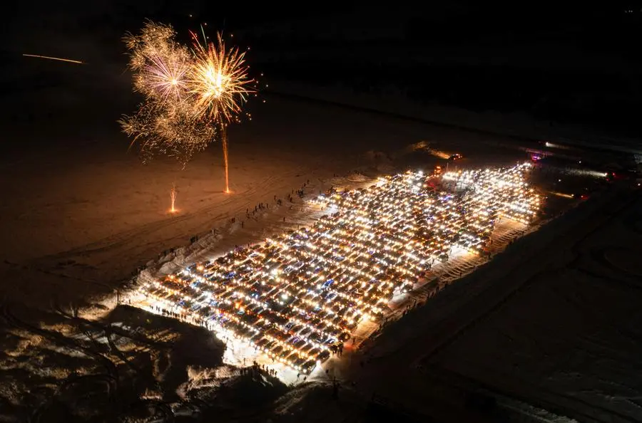 Participants make an attempt to set a Russian record by parking about 800 vehicles appropriately to form the shape of a Christmas tree during a flashmob marking the upcoming New Year and Christmas season in the Siberian city of Krasnoyarsk, Russia, December 23, 2023. REUTERS/Alexander Manzyuk