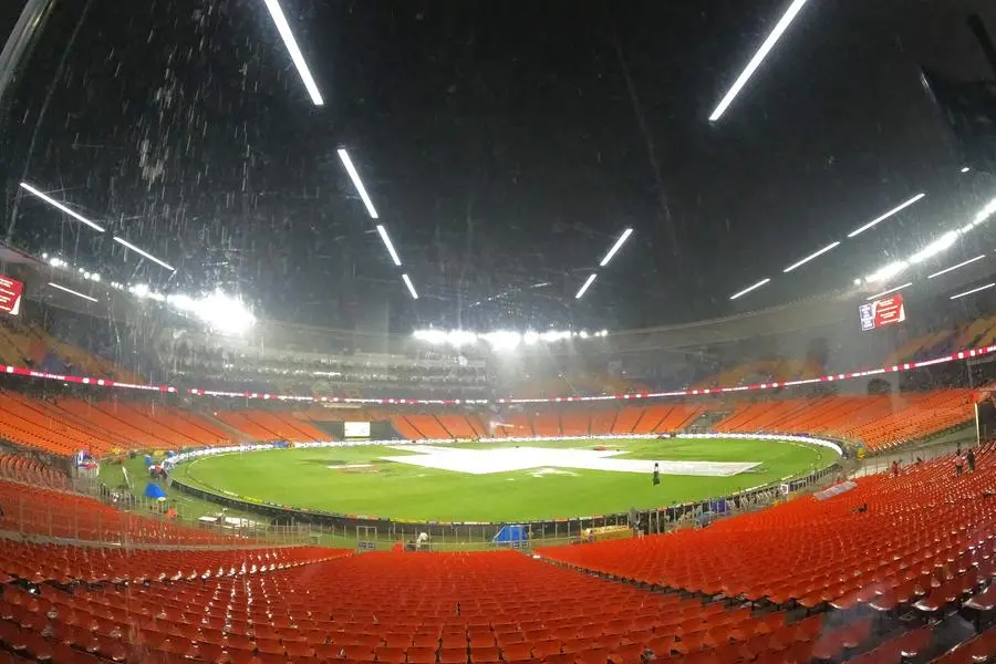 Covered field is pictured as it rains before the start of the Indian Premier League (IPL) Twenty20 final cricket match between Gujarat Titans and Chennai Super Kings at the Narendra Modi Stadium in Ahmedabad on May 28, 2023. (Photo by Sajjad HUSSAIN / AFP)