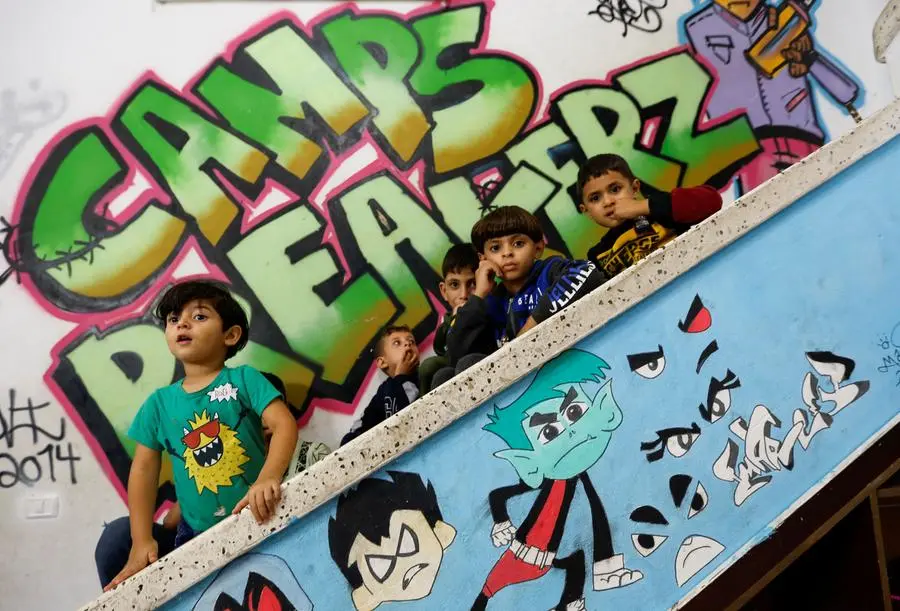 Palestinian children watch a breakdance performance at a training centre in Nusseirat refugee camp in central Gaza Strip, October 14, 2022. REUTERS/Ibraheem Abu Mustafa