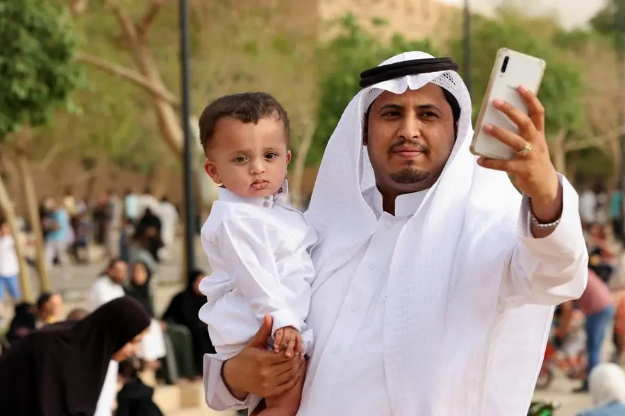 A Saudi man takes a selfie with his son during Eid al-Fitr celebration at the King Abdul Aziz Mosque, in Riyadh, Saudi Arabia, May 2, 2022. REUTERS/Ahmed Yosri , Reuters