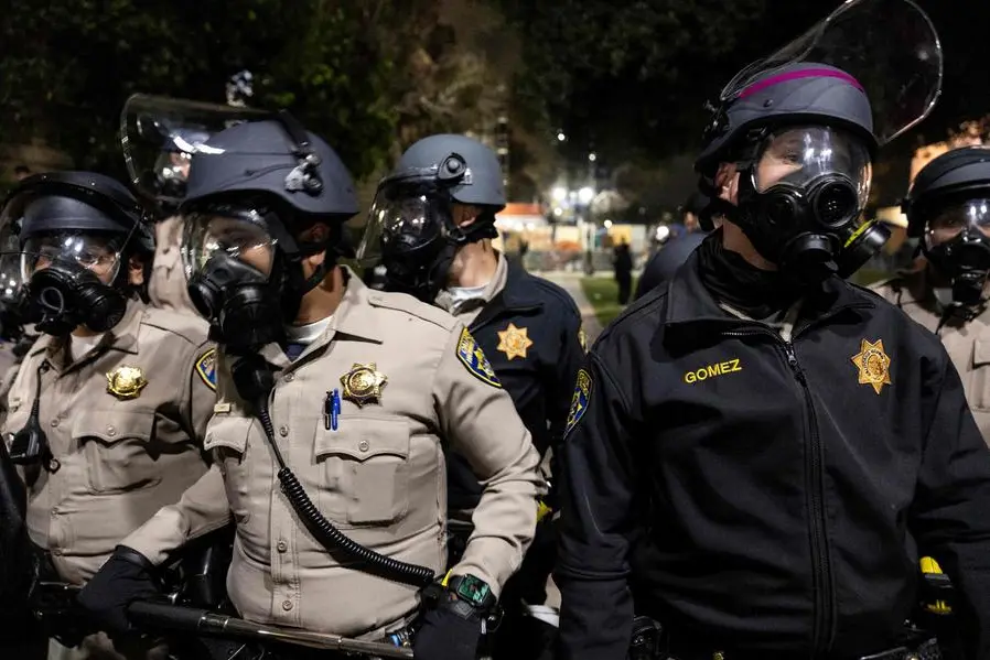 US Police officers stand guard near a pro-Palestinian encampment set up on the campus of the University of California Los Angeles (UCLA), after clashes erupted in Los Angeles on May 1, 2024. Clashes broke out on May 1, 2024 around pro-Palestinian demonstrations at the University of California, Los Angeles, as universities around the United States struggle to contain similar protests on dozens of campuses. (Photo by ETIENNE LAURENT / AFP) , Agence France-Presse (AFP)/AFP