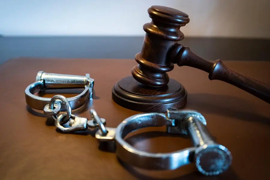 Gavel and handcuffs on a leather surface. Image used for illustrative purpose. Getty Images , Getty Images
