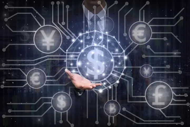 Businessman hand holding the Futuristic Technology connection shape on the Abstract photo of FINTECH connection over the digital number background, Showing the cryptocurrency or digital money , Getty Images/Getty Images