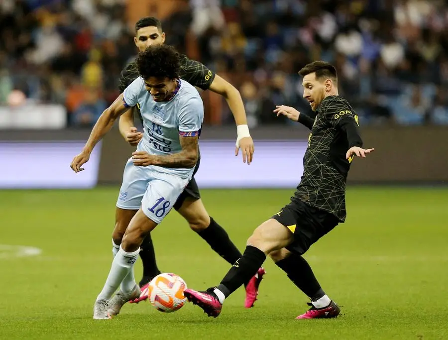 Soccer Football - Friendly - Saudi Pro League XI v Paris St Germain - King Fahd International Stadium, Riyadh, Saudia Arabia - January 19, 2023 Paris St Germain's Lionel Messi in action with Saudi Pro League XI's Luiz Gustavo REUTERS/Ahmed Yosri