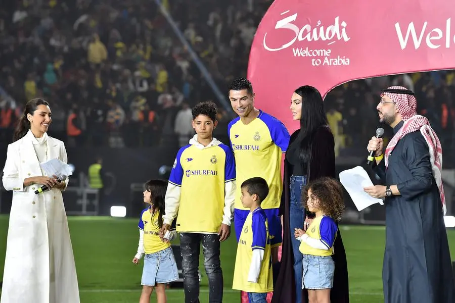 Al-Nassr's new Portuguese forward Cristiano Ronaldo (C), his partner Georgina Rodriguez (C-L) and his children stand on the stage during his unveiling at the Mrsool Park Stadium in the Saudi capital Riyadh on January 3, 2023. (Photo by AFP)