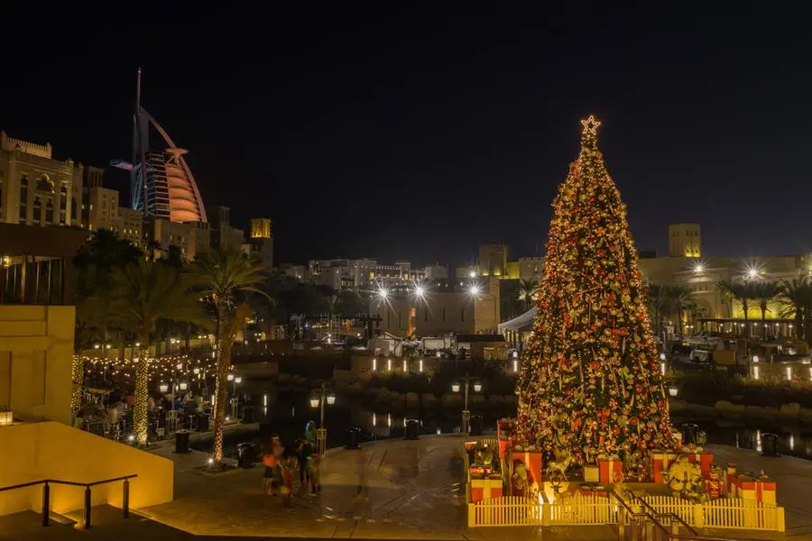 A Christmas tree surrounded by lights and buildings in Souk Madinat Jumeirah in Dubai. Getty Images