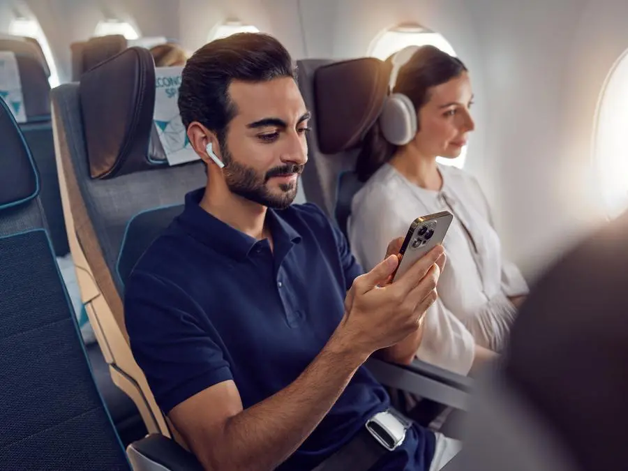 Etihad Airways Economy Class with guest taking advantage of Etihad's unlimited Wi-fly. Image courtesy: Etihad Airways