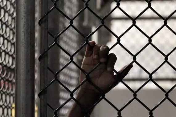 Image used for illustrative purpose. In this photo reviewed by a U.S. Department of Defense official, a Guantanamo detainee holds onto a fence inside the Camp 6 high-security detention facility at Guantanamo Bay U.S. Naval Base April 27, 2010. REUTERS/Michelle Shephard/Pool , Michelle Shephard/Pool