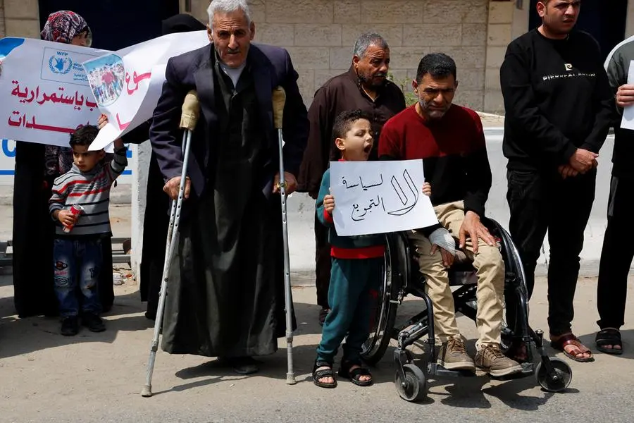 Palestinians attend a gathering outside UN offices to protest a decision by World Food Program to suspend aid of around 200,000 people in the Gaza Strip and the West Bank, in Gaza City, May 7, 2023. REUTERS/Mohammed Salem , Reuters/REUTERS