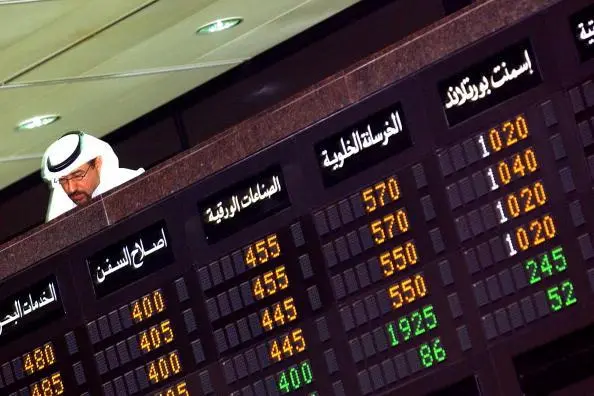 KUWAIT CITY-KUWAIT APRIL 23: A Kuwaiti investor looks onto the trading floor at the Kuwait Stock Exchange April 23, 2003 in Kuwait City, Kuwait. The stock exchange, established in 1983, has been reaching record highs in vigorous trading. (Photo by Graeme Robertson/Getty Images) , Getty Images/Getty Images