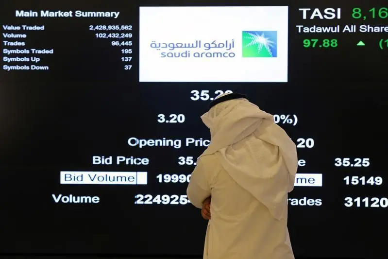 An investor monitors a screen displaying stock information at the Saudi Stock Exchange (Tadawul) following the debut of Saudi Aramco\\'s initial public offering (IPO) on the Riyadh\\'s stock market, in Riyadh, Saudi Arabia, December 11, 2019. Ahmed Yosri, Reuters , Reuters Images