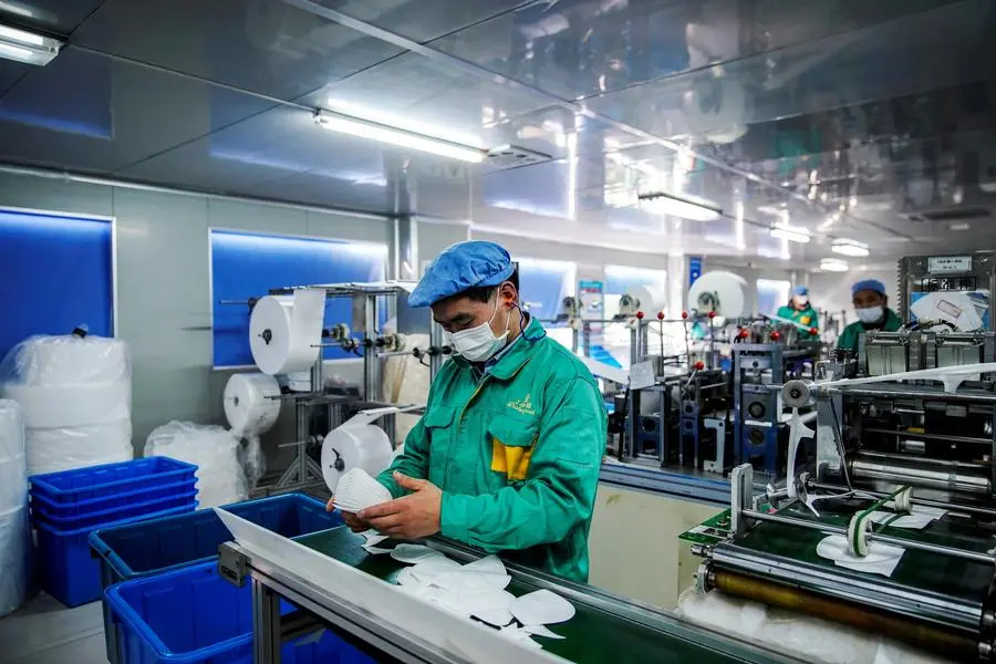 FILE PHOTO: Workers are seen on a production line manufacturing masks at a factory in Shanghai, China January 31, 2020. Picture taken January 31, 2020. REUTERS/Aly Song/File Photo , REUTERS