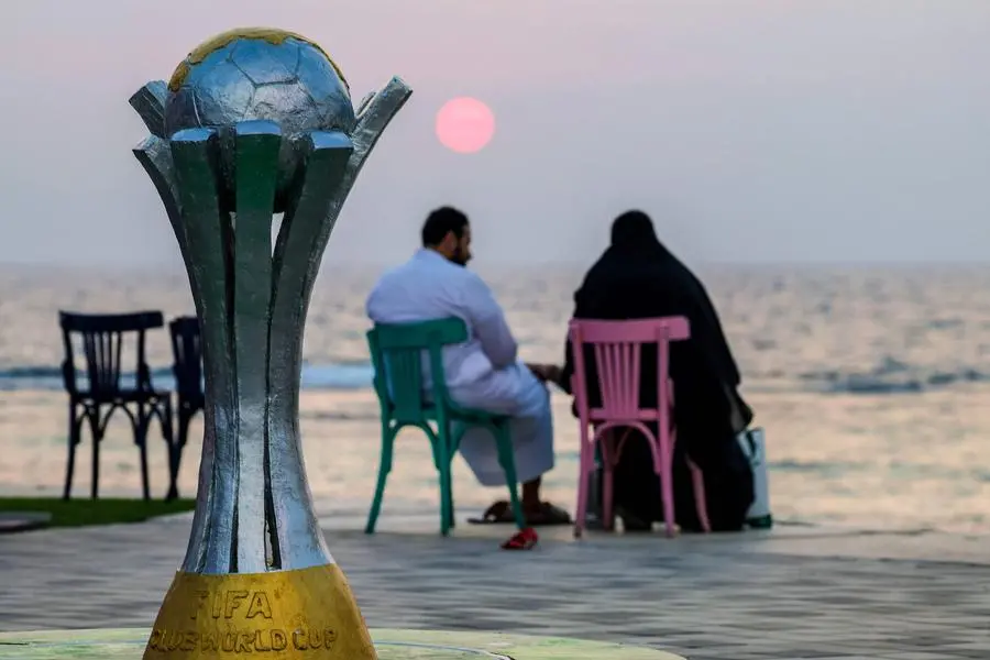 A couple sits during sunset at the Fifa Club World Cup Fan Village in the Saudi Red Sea resort town of Jeddah on December 20, 2023. (Photo by Giuseppe CACACE / AFP) , Agence France-Presse (AFP)/AFP