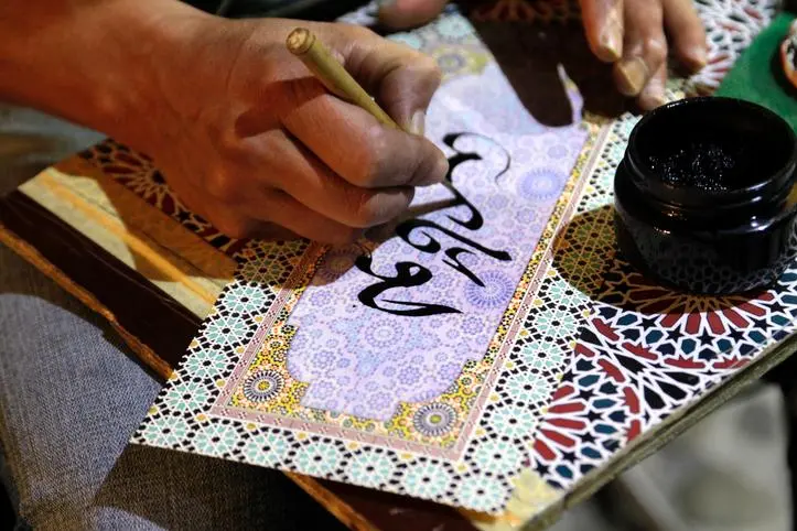 Close-up of Man Writing Arabic Calligraphy , Getty Images/Getty Images