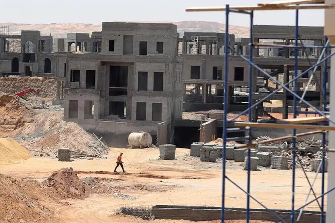 Image used for illustrative purpose. Worker walks in front of buildings under construction in the New Administrative Capital (NAC), east of Cairo, amid concerns about the spread of the coronavirus disease (COVID-19), in Egypt May 6, 2020. , Mohamed Abd El Ghany