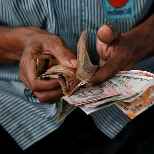 Indian rupee inches up on yuan recovery, dollar index pullback; premiums tumble