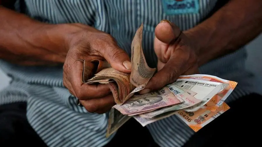 Indian rupee ends higher; traders await RBI policy