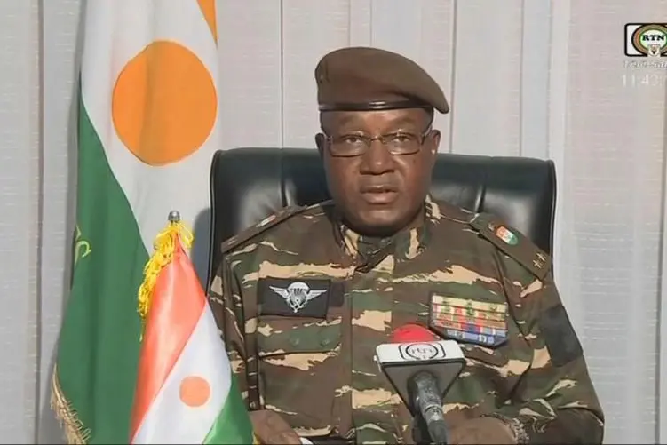 This video frame grab image obtained by AFP from ORTN - T\\uFFFDl\\uFFFD Sahel on July 28, 2023 shows General Abdourahamane Tchiani, Niger\\uFFFDs new strongman, speaking on national television and reads a statement as \"President of the National Council for the Safeguarding of the Fatherland\", after the ouster of President-elect Mohamed Bazoum. The chief of the Presidential Guard justifies the coup by evoking \"the continued deterioration of the security situation\" in the country, as well as \"poor economic and social governance\". (Photo by ORTN - T\\uFFFDl\\uFFFD Sahel / AFP) , Agence France-Presse (AFP)