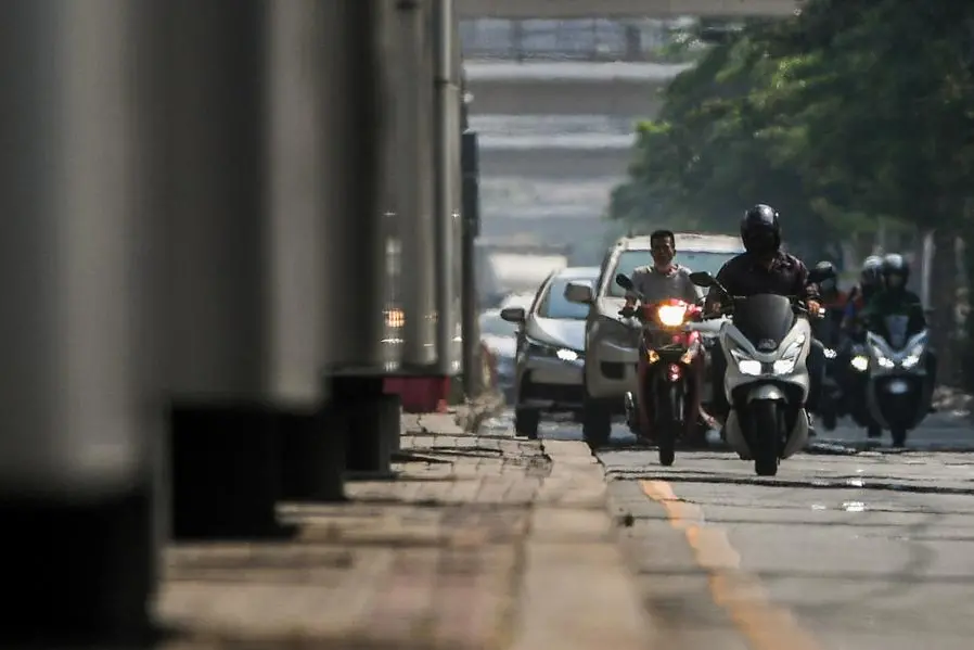 Motorbike riders are seen through heat haze as temperatures hit a record 45.4 degrees Celsius (113.7 Fahrenheit) in Bangkok, Thailand, April 21, 2023. REUTERS/Chalinee Thirasupa , Reuters/REUTERS