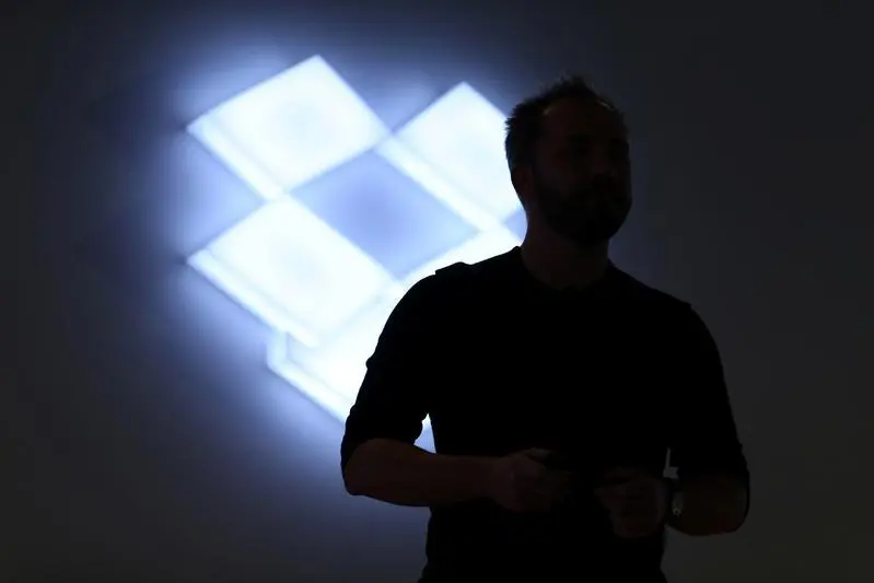 Drew Houston, Chief Executive Officer and founder of Dropbox, stands in front of the company\\'s logo at an announcement event in San Francisco, California, U.S., January 30, 2017. REUTERS/Beck Diefenbach - RTX2YW3U , Reuters Images