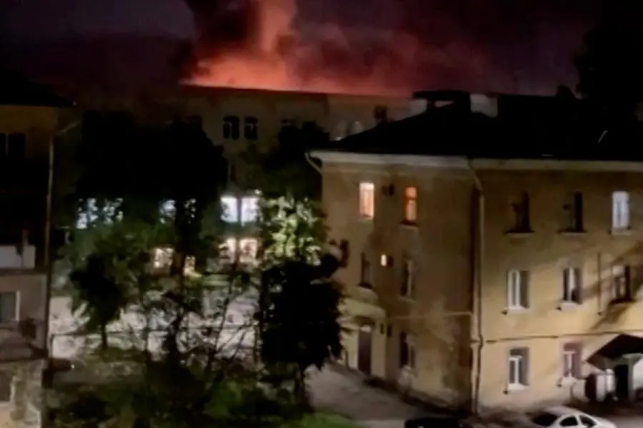 A plume of smoke is illuminated by a flash of light amid a drone attack in Pskov, Russia, in this still image obtained from social media video released August 30, 2023. TELEGRAM / MIKHAIL VEDERNIKOV/via REUTERS