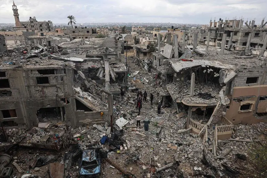 TOPSHOT - Palestinians inspect the destruction caused by Israeli strikes on their homes in the village of Khuzaa, east of Khan Yunis near the border fence between Israel and the southern Gaza Strip on November 27, 2023, amid a truce in battles between Israel and the Palestinian militant group Hamas. The Israeli government said today it had put Hamas \\\"on notice\\\" that an \\\"option for an extension\\\" of the truce in the Gaza Strip was open. (Photo by SAID KHATIB / AFP)