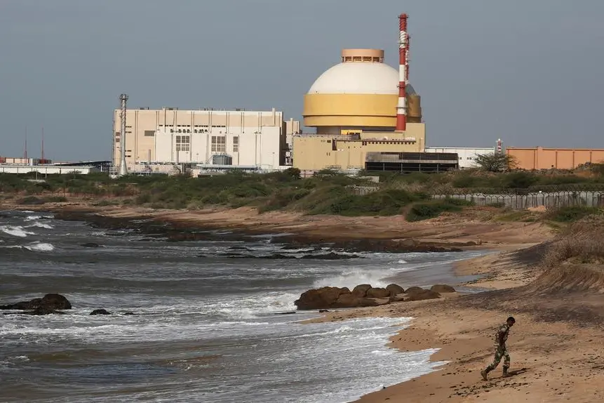 FILE PHOTO: A policeman walks on a beach near the Kudankulam nuclear power project in the southern Indian state of Tamil Nadu on September 13, 2012. REUTERS/Adnan Abidi/File Photo , Reuters
