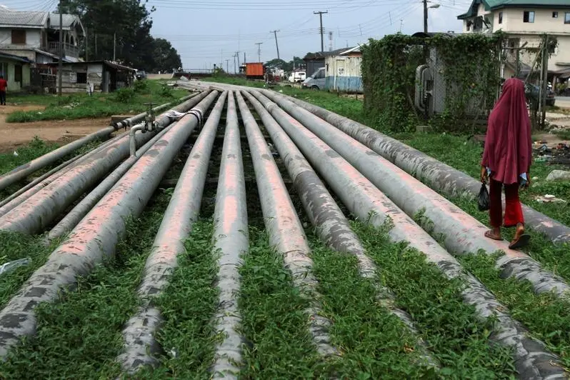 A girl walks on a gas pipeline running through Okrika community near Nigeria\\'s oil hub city of Port Harcourt December 4, 2012. Akintunde Akinleye, Reuters Image for illustrative purposes , Reuters Images