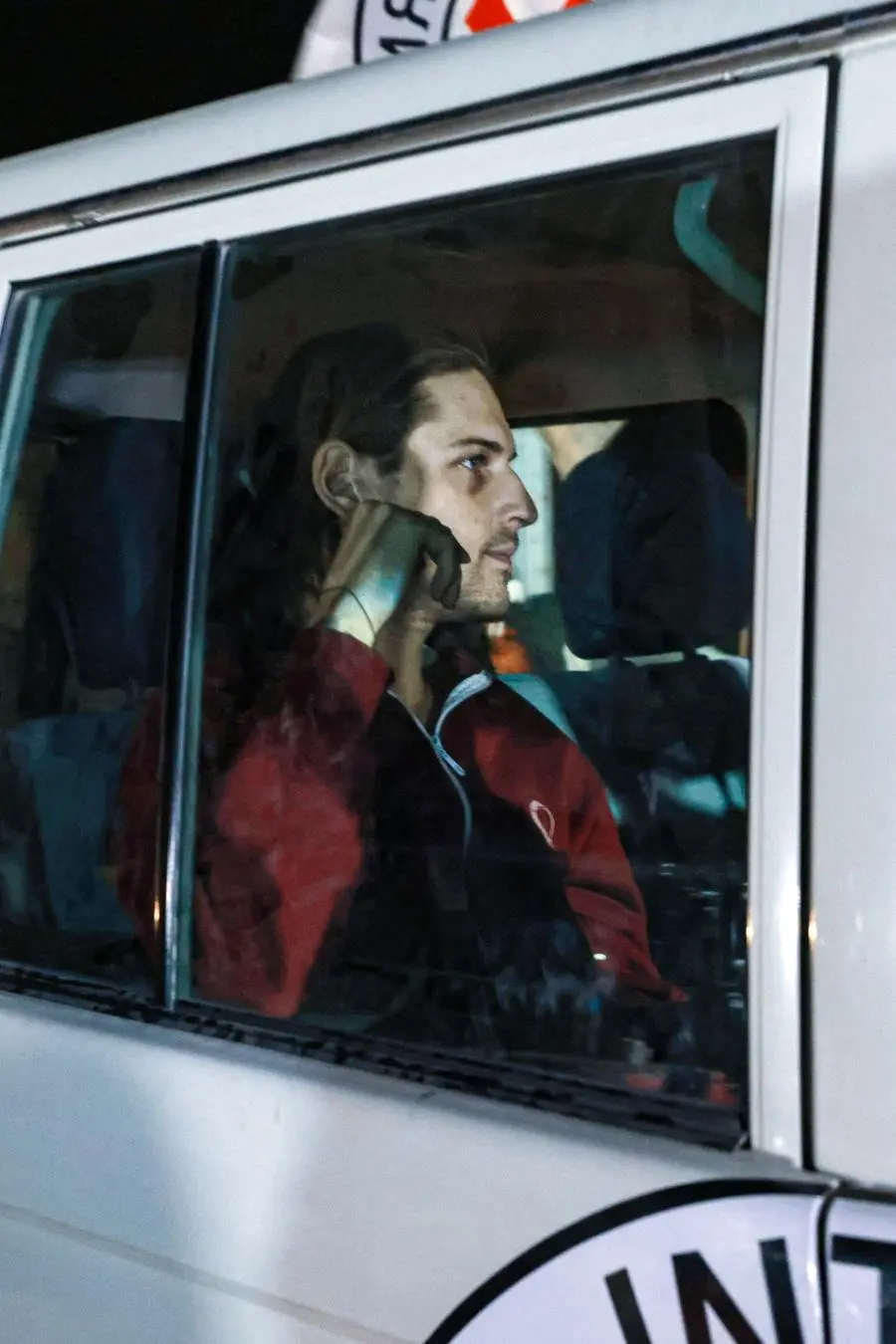 An International Red Cross vehicle carrying Israeli Russian hostage Ron Krivoy released by Hamas drives towards the Rafah border point with Egypt ahead of a transfer to Israel on November 26, 2023. The Israeli army said in a statement on November 26, 2023 that 13 released hostages were back on Israeli territory, and another four were on their way via the Rafah crossing between the Gaza Strip and Egypt. (Photo by MOHAMMED ABED / AFP)