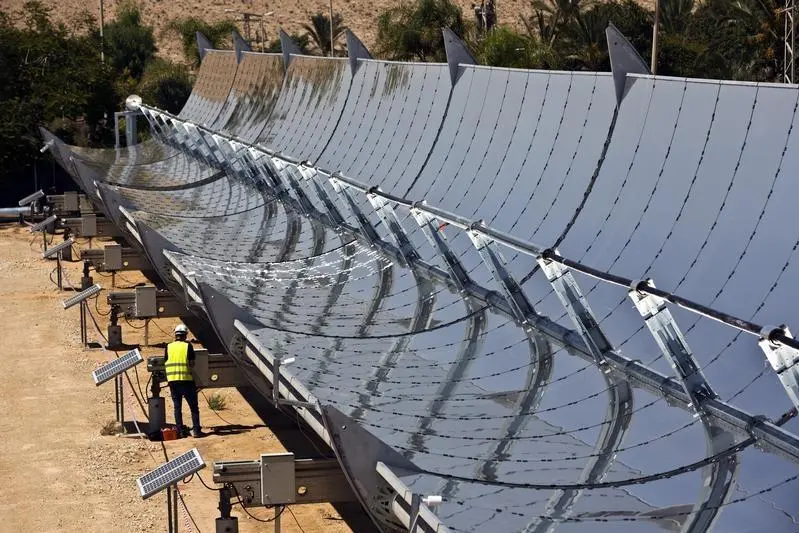 Image used for illustrative purpose. A worker stands next to parabolic mirrors tracking the sun at the research site of solar power company Brenmiller Energy in Israel\\'s Negev desert, near the town of Dimona September, 9, 2014. Brenmiller Energy says it has developed a new, more efficient way to store heat from the sun that could give a boost to the thermal solar power industry by enabling plants to run at full capacity night and day. Picture taken September 9, 2014. REUTERS/ Nir Elias , Reuters Images/ Nir Elias 