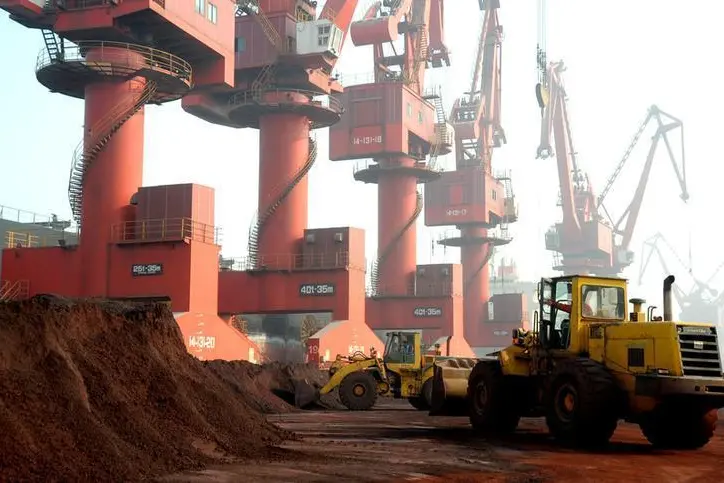 Workers transport soil containing rare earth elements for export at a port in Lianyungang, Jiangsu province, China October 31, 2010. Picture taken October 31, 2010. REUTERS/Stringer