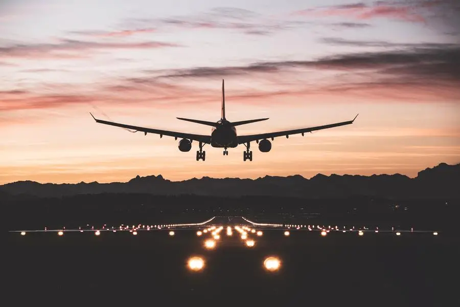 An airplane moments from touching down on the runway at sunrise. Getty Images Image used for illustrative purpose. , Getty Images