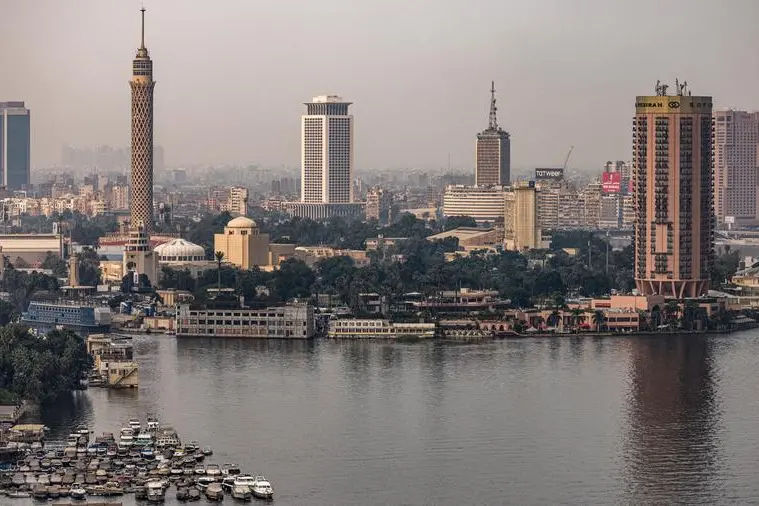 This picture taken on November 1, 2022 shows a view of the skyline of Egypt\\'s capital Cairo, showing the landmark Cairo Tower (2nd-L) built in 1961, the Cairo Opera House (3rd-L below), the high-rise building used as the headquarters of the foreign ministry (C), the Egyptian Radio and Television Union headquarters building (3rd-R), and the Sofitel (2nd-R) and Ramses Hilton (R) hotel buildings. (Photo by Amir MAKAR / AFP) Image used for illustrative purpose.