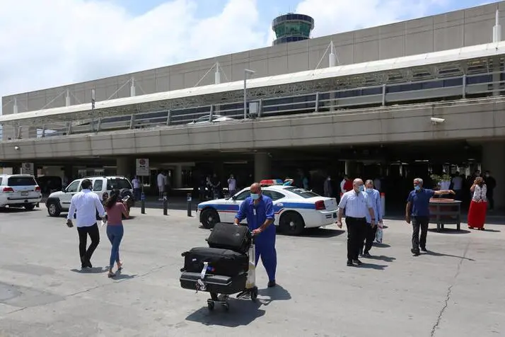 A worker pushes luggage outside Beirut international airport on its re-opening day following the coronavirus disease (COVID-19) outbreak, in Beirut, Lebanon July 1, 2020. REUTERS/Aziz Taher , Reuters Images/REUTERS
