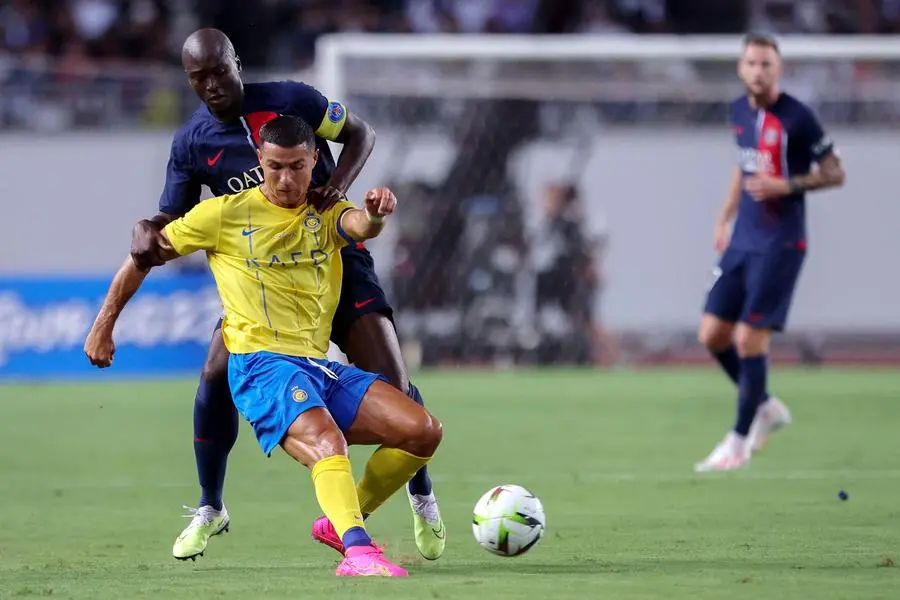 Paris Saint-Germain\\'s Danilo Pereira (back) fights for the ball with Al-Nassr\\'s Cristiano Ronaldo during the friendly football match between France\\'s Paris Saint-Germain and Saudi Arabia\\'s Al-Nassr at Nagai Stadium in Osaka on July 25, 2023. (Photo by PAUL MILLER / AFP) , Agence France-Presse (AFP)