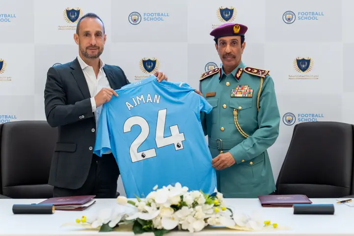 <p>Olivier Turkel, Regional Director, City Football - Middle East (left) with H.E. Major General Sheikh Sultan bin Abdullah Al Nuaimi, Commander in Chief of Ajman Police, hold a Man City &lsquo;Ajman 24&rsquo; jersey during a signing ceremony</p>\\n