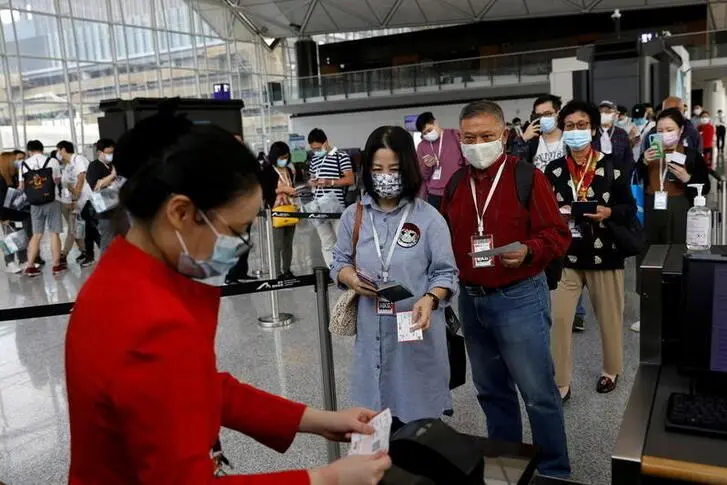 A Hong Kong Airline\\'s employee checks passengers\\' documents before boarding for Hong Kong Airline\\'s Embrace \"Home\" Kong \"flight to nowhere\" experience, at Hong Kong International Airport, following the coronavirus disease (COVID-19) outbreak, in Hong Kong, China October 24 2020. REUTERS/Tyrone Siu , Reuters Images/REUTERS