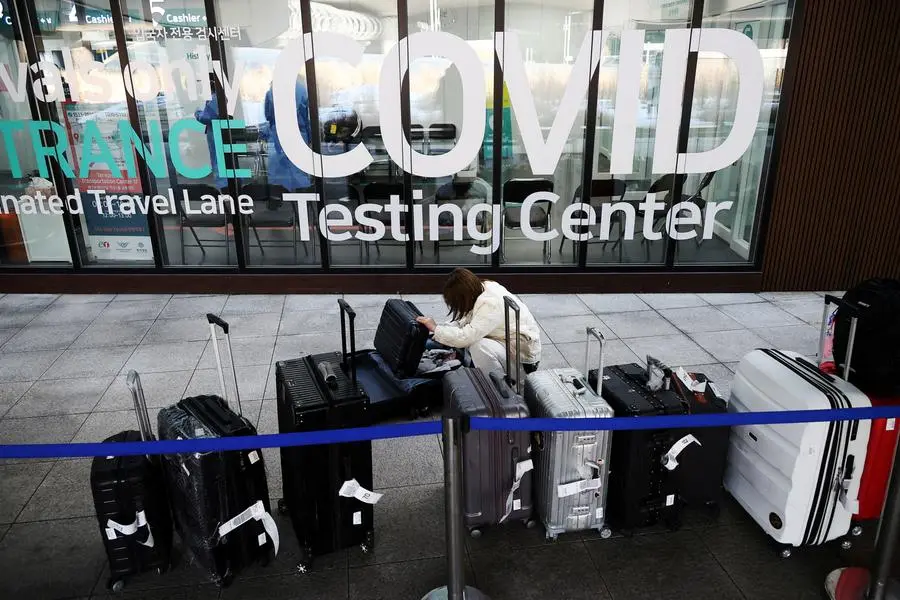 FILE PHOTO: A Chinese tourist checks her luggage as she is waiting for her coronavirus disease (COVID-19) test result upon her arrival at the Incheon International Airport in Incheon, South Korea, January 4, 2023. REUTERS/Kim Hong-Ji/File Photo , Reuters