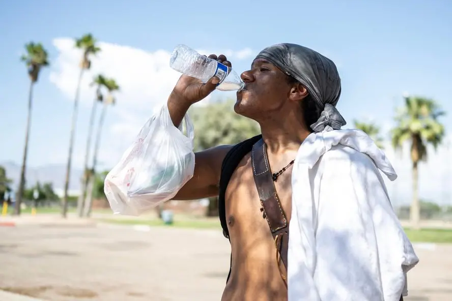 Alonzo McAdams drinks a bottle of water given to him from a Salvation Army truck handing out water, and other supplies for the homeless in Tucson, Arizona on July 26, 2023. A record-breaking heat wave stretching across the southern United States is expected to expand in the coming days and weeks, as scientists warn July will likely be the hottest month ever recorded. As of Wednesday, July 26, Tucson set a new record for consecutive days of 100-plus-degree temperatures with 40, dating back to June 16 of this year. (Photo by ANDREW CABALLERO-REYNOLDS / AFP) , Agence France-Presse (AFP)/AFP
