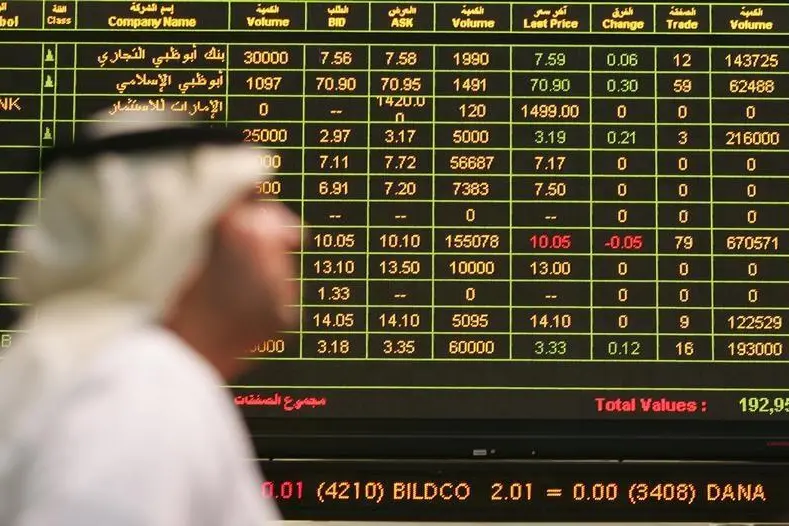 A trader walks past the quotation board at the Abu Dhabi stock market July 11, 2006. Image used for illustrative purpose.
