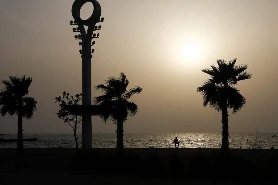 A man sits at the beach during the sunset as the temperature drops, after it reached 43 degrees during the day in Dubai, UAE, July 14, 2023. REUTERS/Rula Rouhana , Reuters