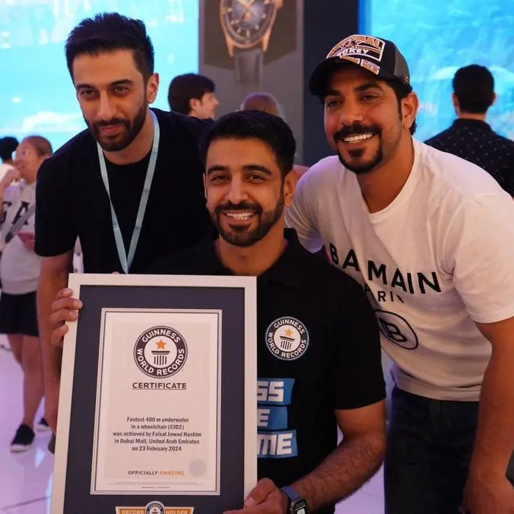 Faisal Al Mosawi sets a new Guinness World Record for fastest dive with underwater wheelchair at Dubai Aquarium
